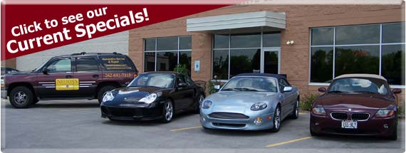Nelson's Automotive shop exterior with vehicles